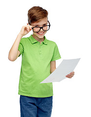 Image showing happy boy in eyeglasses holding school test result