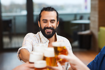 Image showing man clinking beer glass with friends at restaurant