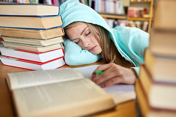 Image showing student or woman with books sleeping in library