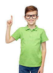 Image showing happy boy in eyeglasses pointing finger up