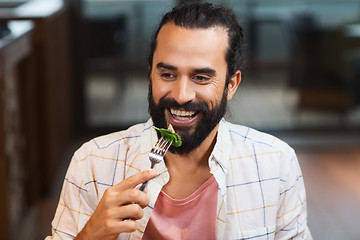 Image showing happy man having dinner at restaurant