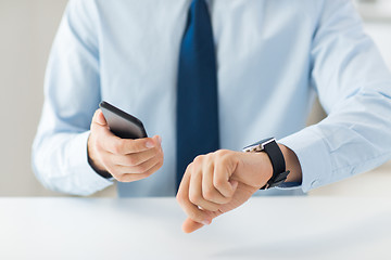 Image showing close up of hands with smart phone and watch