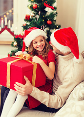 Image showing smiling father and daughter opening gift box