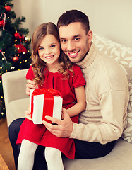 Image showing smiling father and daughter holding gift box