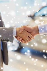 Image showing close up of male handshake in auto show or salon