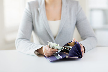 Image showing close up of woman hands with wallet and money
