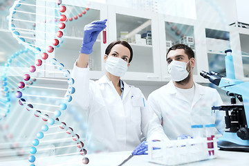 Image showing scientists with test tubes making research in lab