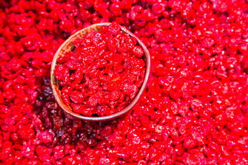 Image showing Scoop of dry cranberries.