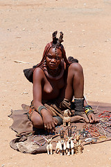 Image showing Himba girl with souvenirs for sale in traditional village