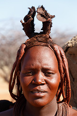 Image showing Himba woman with ornaments on the neck in the village