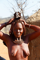 Image showing Himba woman with ornaments on the neck in the village