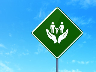 Image showing Insurance concept: Family And Palm on road sign background