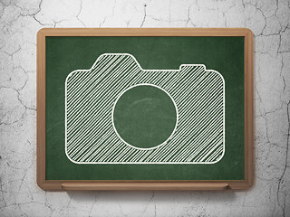 Image showing Travel concept: Photo Camera on chalkboard background