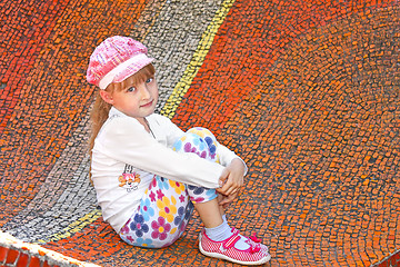 Image showing Little girl sitting on the big mosaic panel