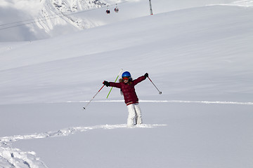 Image showing Happy girl on off-piste slope with new fallen snow at nice sun d