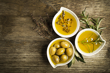 Image showing Olive oil with herbs