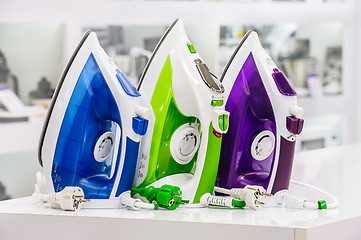 Image showing three electric irons in retail store