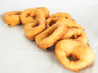 Image showing Freshly made doughnuts in a small pile on baking paper