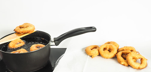 Image showing Fresh made doughnuts from boiling hot oil onto baking paper