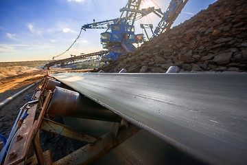 Image showing Long conveyor belt transporting ore