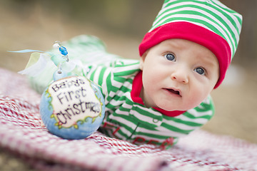 Image showing Infant Baby On Blanket With Babys First Christmas Ornament