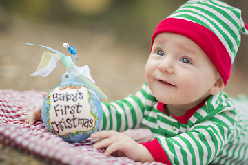 Image showing Infant Baby On Blanket With Babys First Christmas Ornament