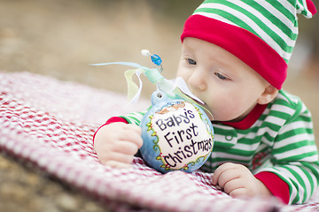 Image showing Infant Baby On Blanket With Babys First Christmas Ornament