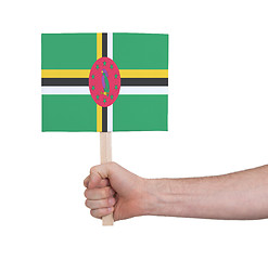 Image showing Hand holding small card - Flag of Dominica