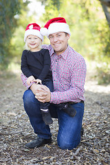 Image showing Portrait of Father and Daughter Wearing Santa Hats