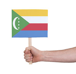 Image showing Hand holding small card - Flag of Comoros