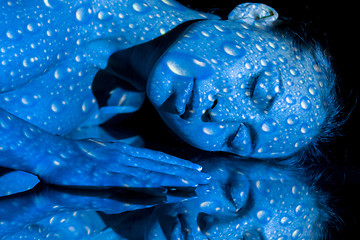 Image showing The  body of woman with blue pattern and its reflection