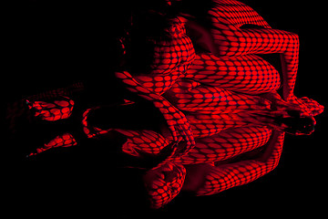 Image showing The  body of woman with red pattern and its reflection