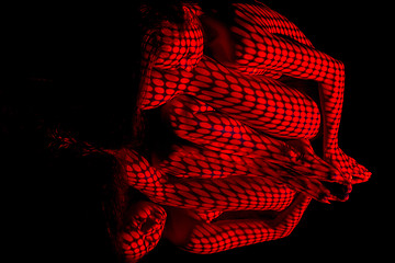 Image showing The  body of woman with red pattern and its reflection