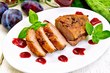 Image showing Duck breast with plum sauce and basil on plate