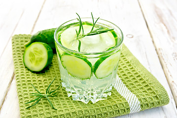 Image showing Lemonade with cucumber and rosemary in glassful on napkin
