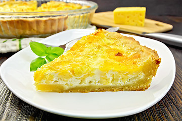 Image showing Pie with cheese and leeks in plate on dark board