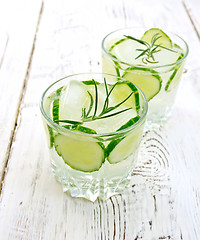 Image showing Lemonade with cucumber and rosemary in two glassful on light boa