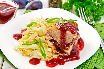 Image showing Duck breast with plum sauce and cabbage in plate