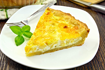 Image showing Pie with cheese and leeks in plate on board