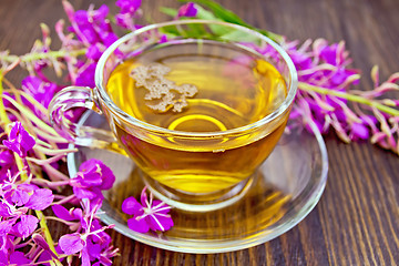 Image showing Tea from fireweed in glass cup on board