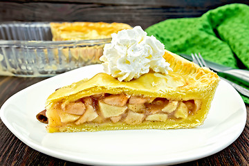 Image showing Pie apple with whipped cream in plate on board
