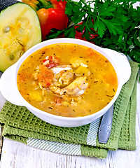 Image showing Soup fish with zucchini and peppers on light board