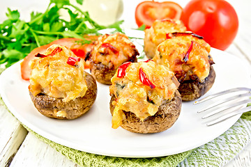 Image showing Champignons stuffed meat in white plate on light board