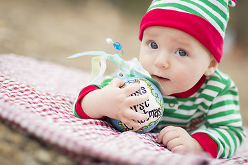 Image showing Infant Baby On Blanket With Babys First Christmas Ornament