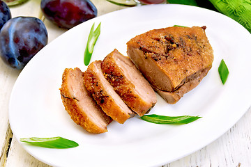 Image showing Duck breast with plum sauce and green onions in white plate