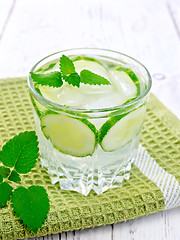 Image showing Lemonade with cucumber and mint in glassful on napkin