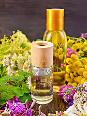 Image showing Oil and lotion with flowers on board