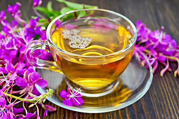 Image showing Tea from fireweed in glass cup on dark board