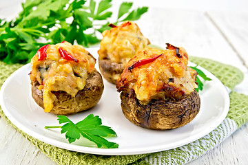 Image showing Champignons stuffed meat in white plate on board