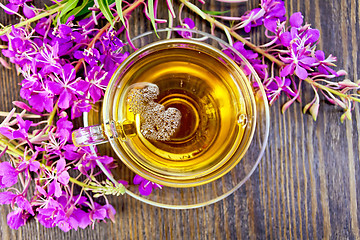 Image showing Tea from fireweed in glass cup on board top